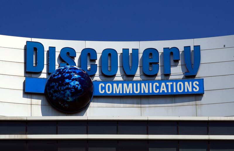 In this July 31, 2017, file photo, the Discovery Communications logo sits atop its headquarters in Silver Spring, Md.
