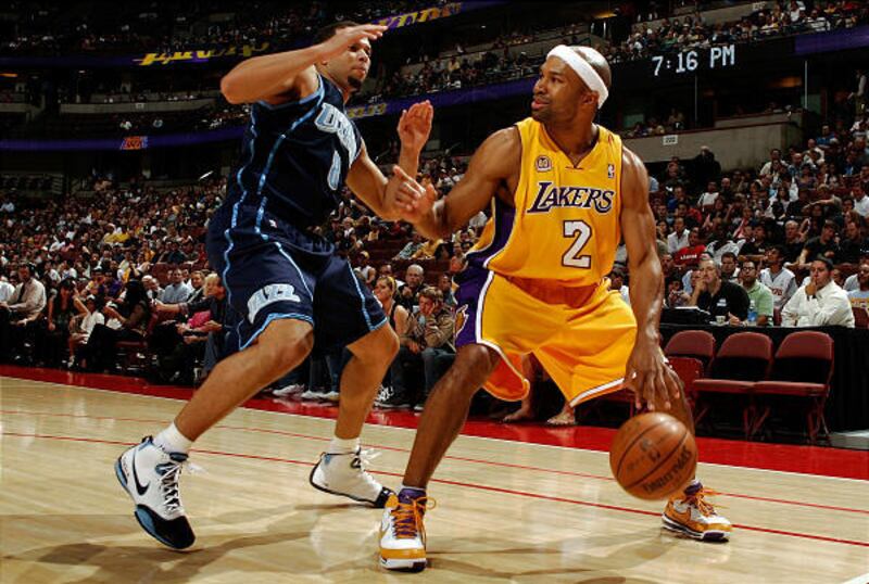 Derek Fisher of the Lakers is guarded by his former Jazz teammate Deron Williams during Tuesday's game in Anaheim. Utah won, 102-81.