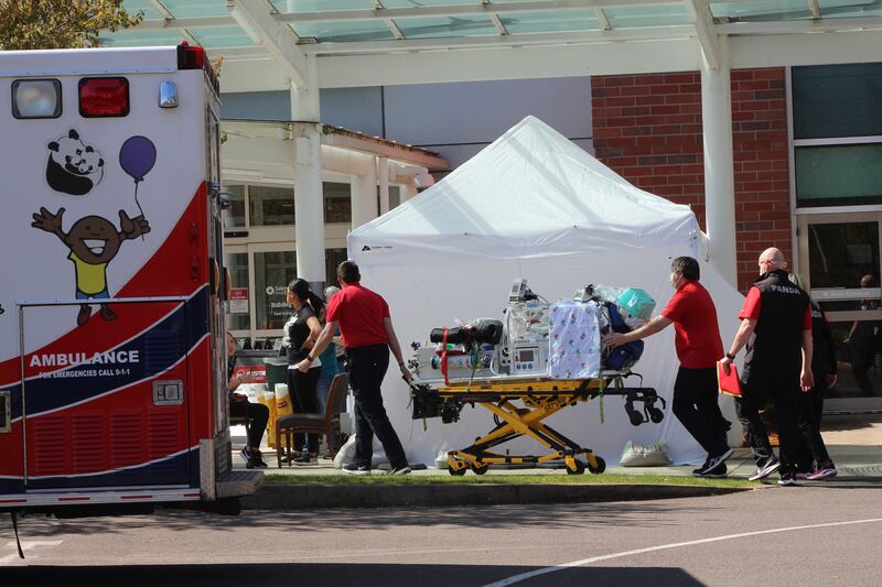 In this April 9, 2020, file photo, healthcare workers wheeling a gurney into Salem Hospital’s emergency room in Salem, Ore., during the coronavirus outbreak. Oregon health officials reported its second-highest tally of confirmed cases of COVID-19 and five additional deaths on Friday, June 26, 2020, the same day that authorities released new modeling that shows increased transmission of the coronavirus since the state began reopening in mid-May.