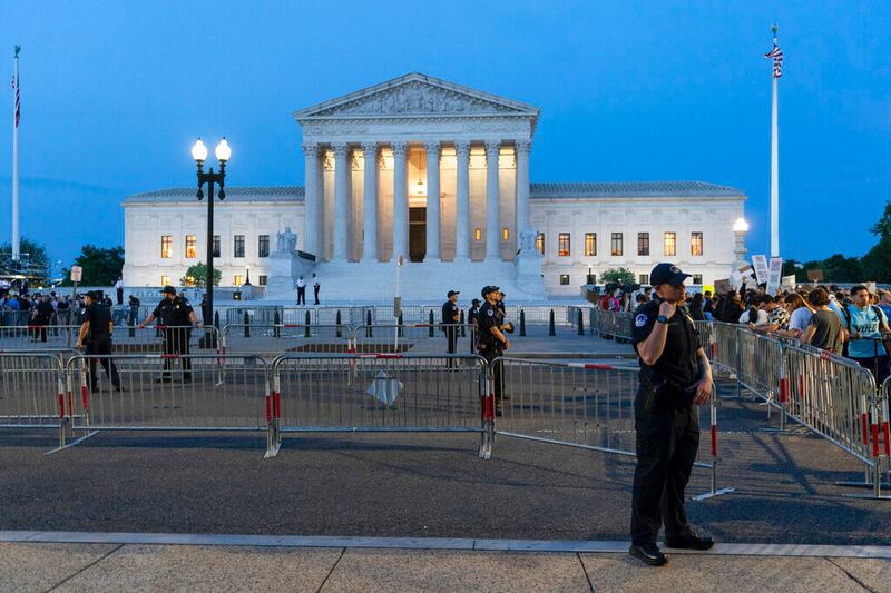 Demonstrators protest outside of the U.S. Supreme Court.