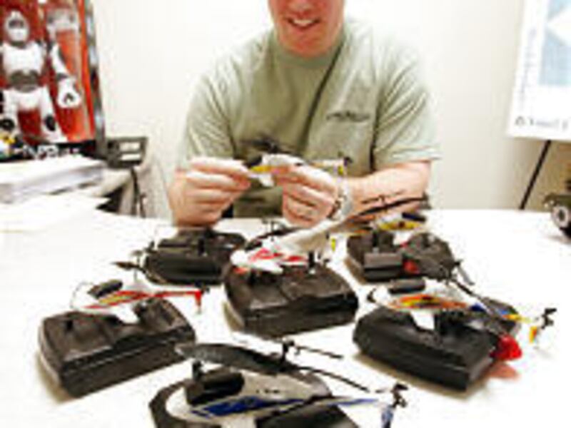 HobbyTron manager John Christiansen holds one of the season's hottest toys \— a tiny remote-controlled helicopter called a Picco Z.