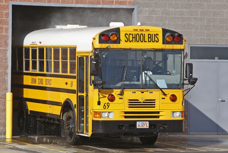 A Jordan School District bus runs through the wash after dropping off students on Wednesday, Feb. 15, 2012, in West Jordan.