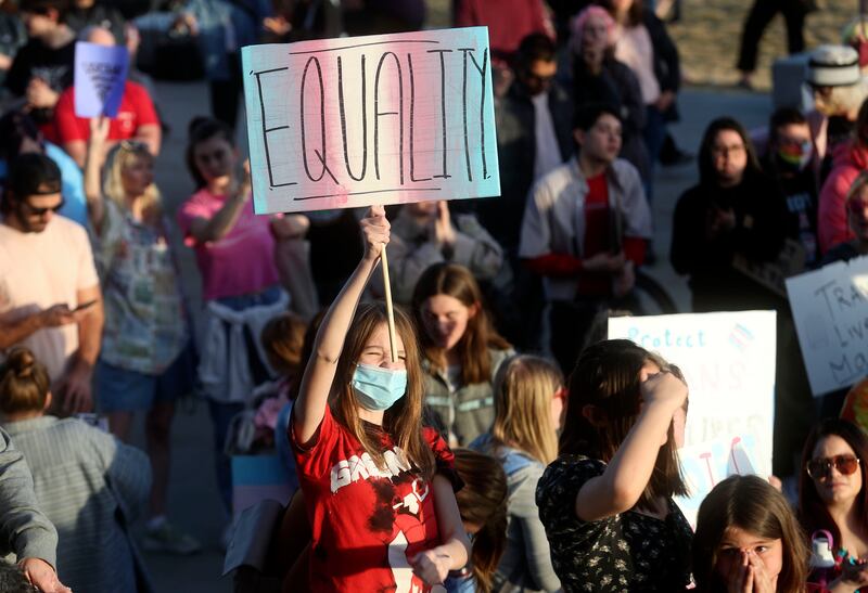 Ariel Peters holds an equality sign during a rally to support transgender youths outside of the Capitol in Salt Lake City.