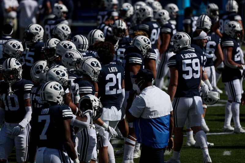 BYU football players warm up prior to a game