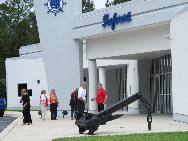 Family, union and company officials wait outside the Seafarer's International Union hall, Sunday, Oct. 4, 2015, in Jacksonville, Fla., as an intensive search resumed Sunday in the southeastern Bahamas for a U.S. cargo ship with 33 people on board. The shi
