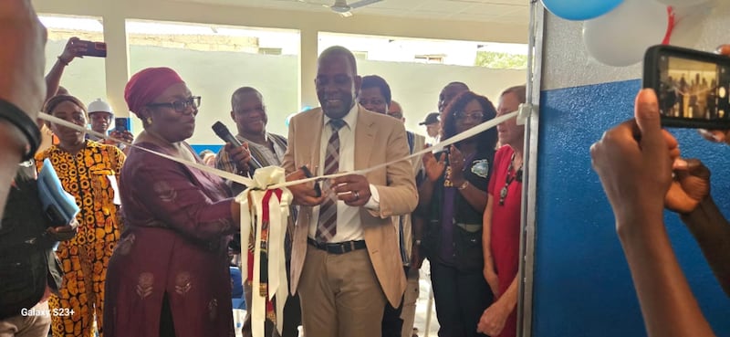 Elder Prince S. Nyanforh, a church Area Seventy in Liberia, and Dr. Catherine T. Cooper, Liberia's chief medical officer, cut a ribbon to formalize the handing over of the Soniwein Health Center on Dec. 27, 2025, in Monrovia, Liberia.