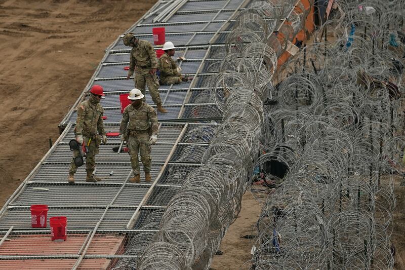 Guardsmen fortify the border along the Rio Grande with concertina wire on Feb. 2, 2024, in Eagle Pass, Texas.