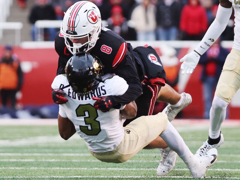 Utah Utes safety Cole Bishop tackles Colorado running back Dylan Edwards (3) in Salt Lake City on Saturday, Nov. 25, 2023.