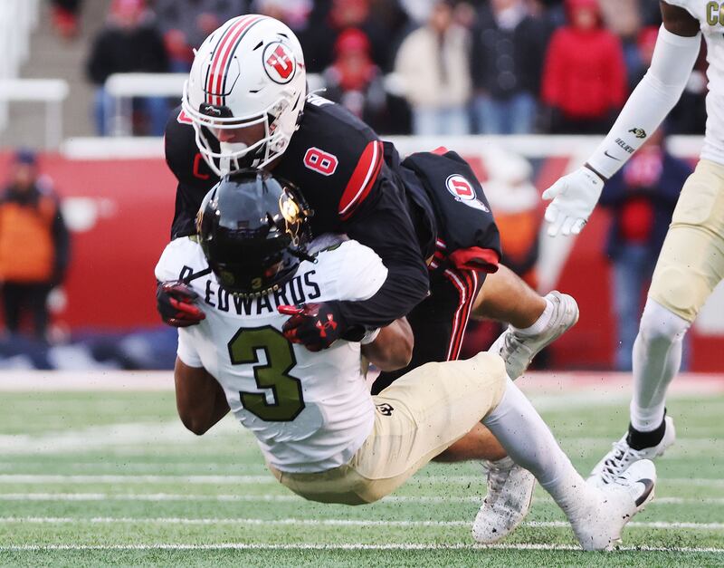 Utah Utes safety Cole Bishop tackles Colorado running back Dylan Edwards (3) in Salt Lake City on Saturday, Nov. 25, 2023.