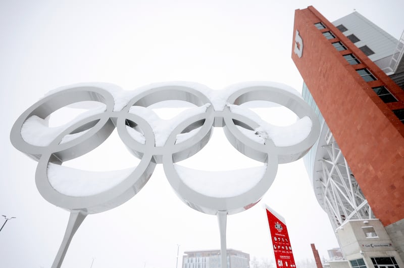 The Olympic rings are pictured covered in snow on Wednesday, Feb. 22, 2023.