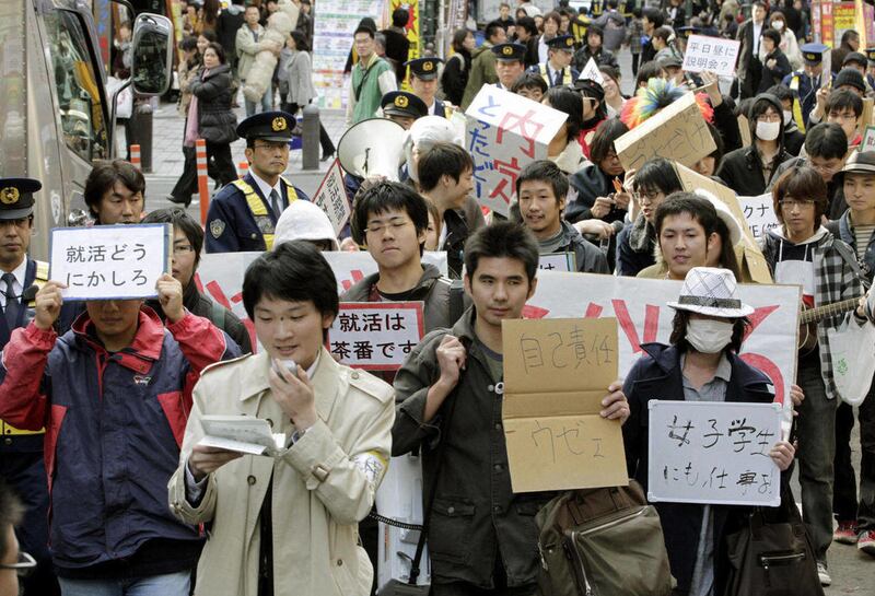In this Nov. 23, 2010 photo, university students looking for jobs demonstrate in Tokyo protesting against early stage start of job hunting and companies hiring new graduates collectively. A record one-third of Japanese university students graduating this