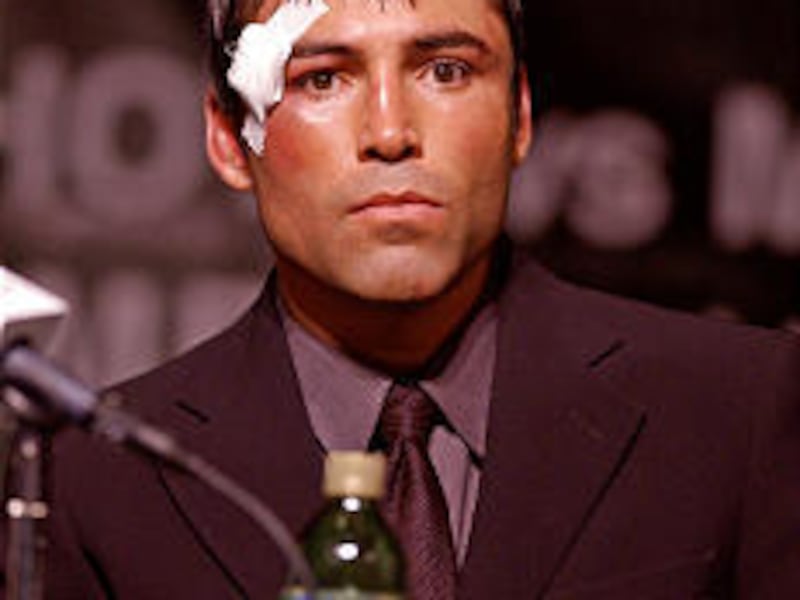 Oscar De La Hoya meets the news following his championship bout against Shane Mosley.