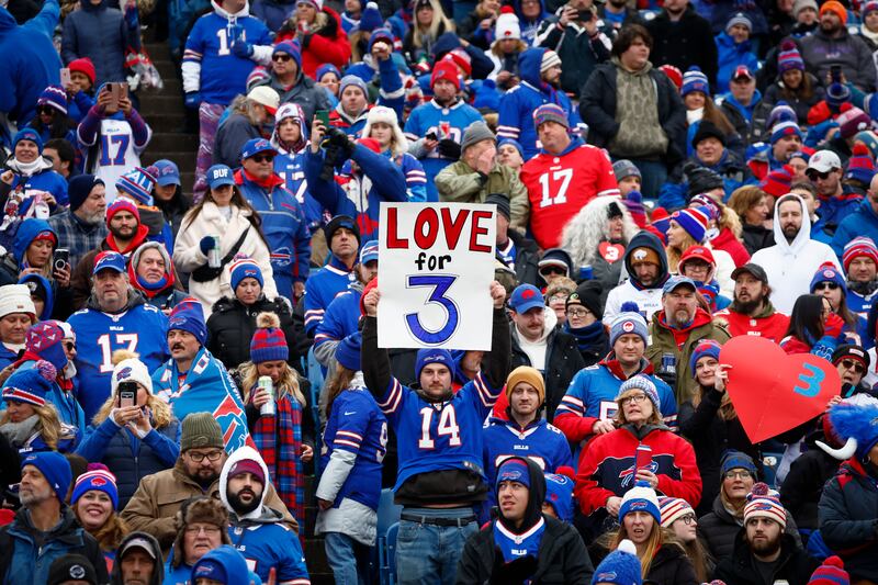 Fans hold signs in support of safety Damar Hamlin before an NFL football game, Sunday, Jan. 8, 2023, in Orchard Park, N.Y.