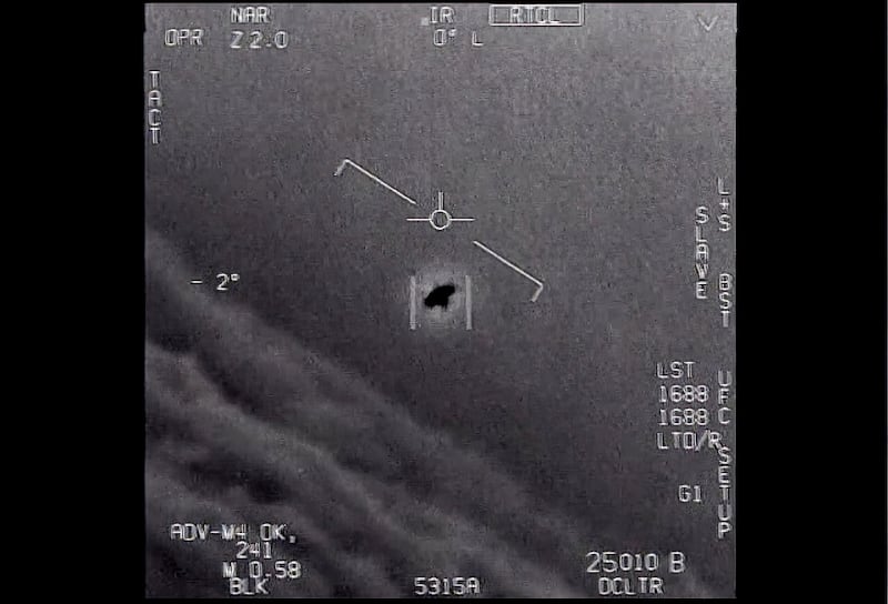 An unexplained object is seen at center as it is tracked as it soars high along the clouds.