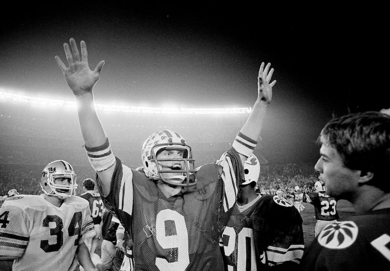 BYU quarterback Jim McMahon raises his arms in celebration as BYU defeated Washington State 38-36 in the Holiday Bowl in San Diego, Dec. 19, 1981.