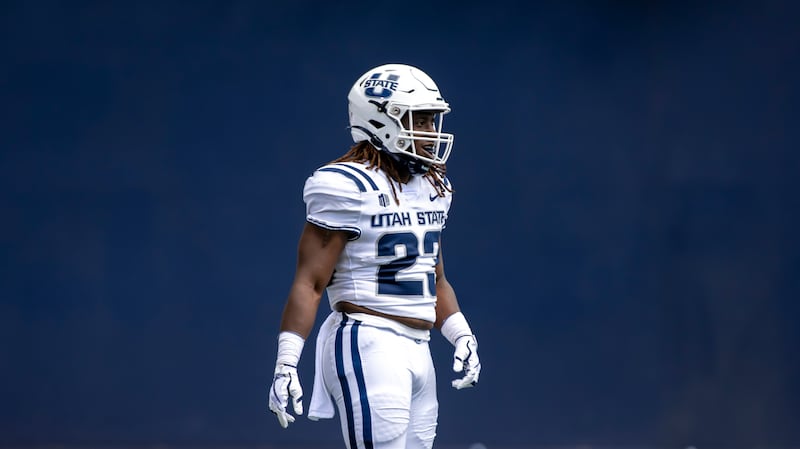 Utah State Aggies running back Jordan Wilmore (23) smiles after a play