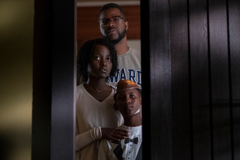 This image released by Universal Pictures shows Winston Duke, Lupita Nyong'o and Evan Alex, right, in a scene from "Us," written, produced and directed by Jordan Peele. (Claudette Barius/Universal Pictures via AP)