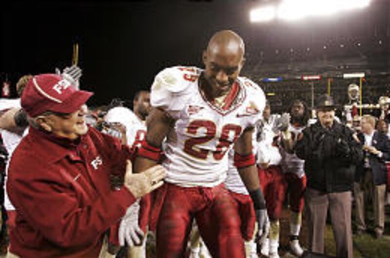 Florida State coach Bobby Bowden congratulates Lorenzo Booker after he won the offensive player of the game for the 2006 Emerald Bowl. The bowl win gave Bowden 30 straight winning seasons.