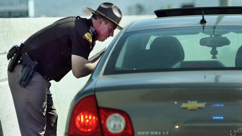 FILE— Trooper Nick Swallow talks with a driver after pulling them over for speeding. Law enforcement agencies gather at Sugarhouse Park for a press conference on Thursday, March 16, 2017, to remind people not to drink and drive.