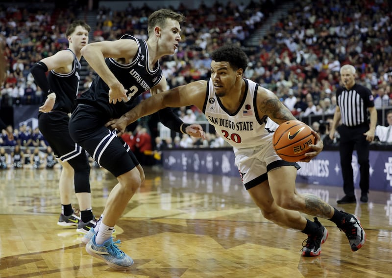 Utah State Aggies guard Steven Ashworth (3) guards San Diego State Aztecs guard Matt Bradley (20) as Utah State and San Diego State play in the Mountain West Conference Basketball Tournament Championship at UNLV’s Thomas and Mack Center in Las Vegas on Saturday, March 11, 2023. San Diego State won 62-57.