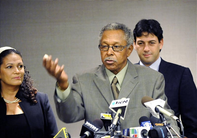Plaintiff Colleen Lawson watches fellow plaintiff Otis McDonald, center, speak during a news conference following a U.S. Supreme Court announcement that it will review the Chicago ban on handguns Wednesday.