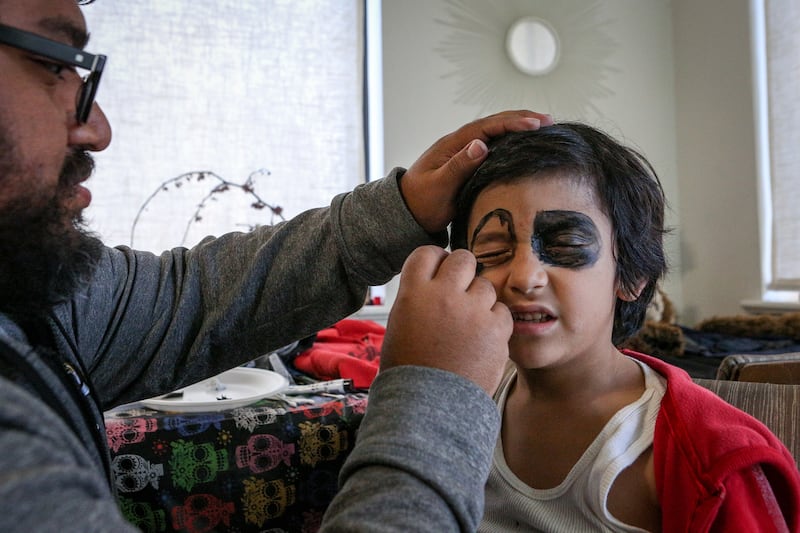 James Estrada applying make-up to his son "J" at their home in Salt Lake City on Monday, Nov. 6, 2017.
