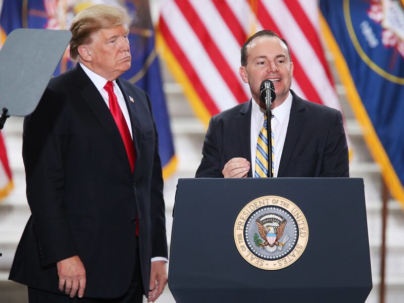 FILE - Sen. Mike Lee, R-Utah, speaks as President Donald Trump looks on at the Capitol in Salt Lake City on Monday, Dec. 4, 2017.