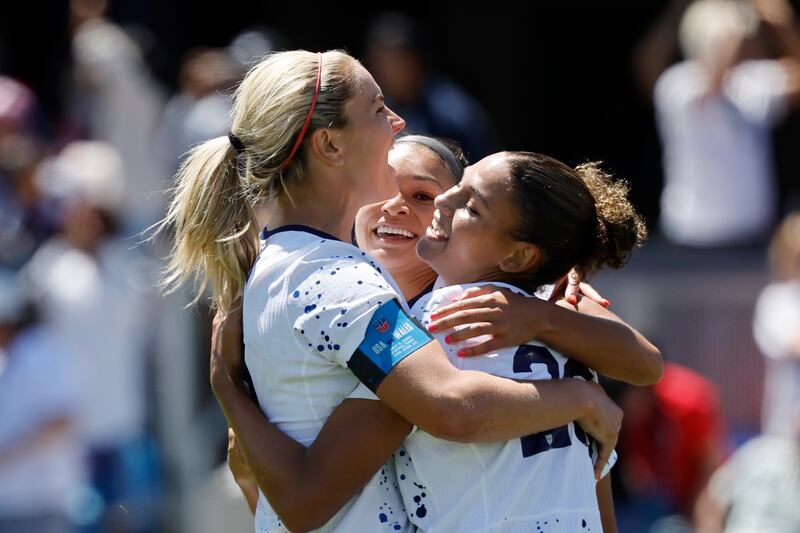 United States midfielder Lindsey Horan, left, and Sophia Smith, center, celebrate with forward Trinity Rodman, right, who scored in the second half of a FIFA Women’s World Cup send-off soccer match against Wales in San Jose, Calif., Sunday, July 9, 2023. (AP Photo/Josie Lepe)