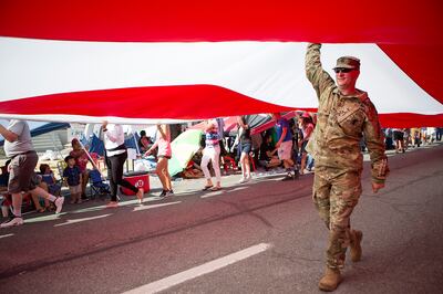 Army Sgt. Ben Winn helps carry Follow the Flag, the largest free flying American flag in the world, during the Days of '47 Parade in Salt Lake City on Tuesday, July 24, 2018.