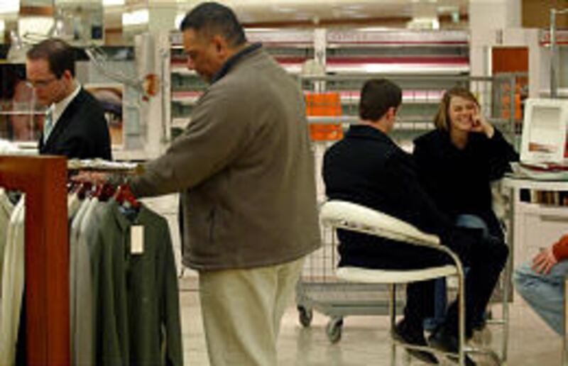 Shopper Maranda Bybee of Pocatello sits in a vacant makeup counter chair at Macy's in the ZCMI Center Saturday.