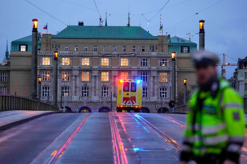 An ambulance drives toward the building of Philosophical Faculty of Charles University in downtown Prague, Czech Republic.