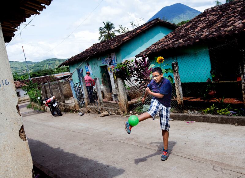 Patrick plays in the street near his home in Jerez, Guatemala, on Monday, Oct. 15, 2018.