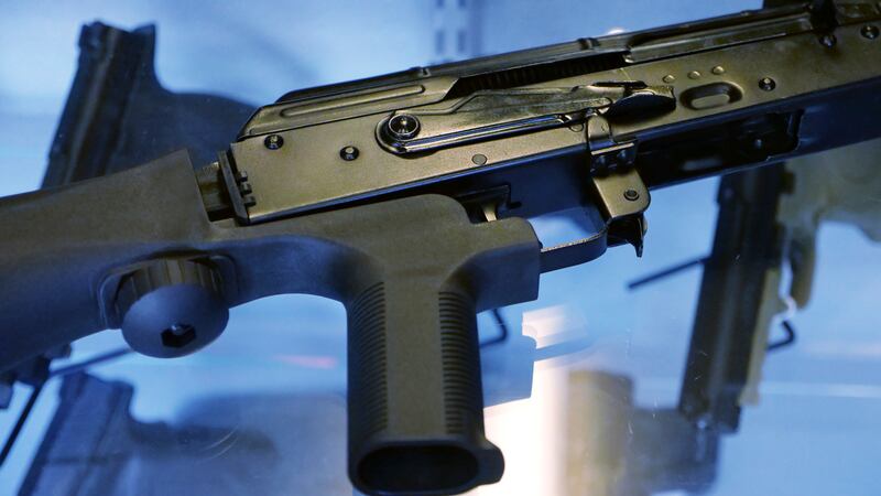 In this 2017 file photo, a device called a “bump stock” is attached to a semi-automatic rifle at the Gun Vault store and shooting range in South Jordan, Utah.