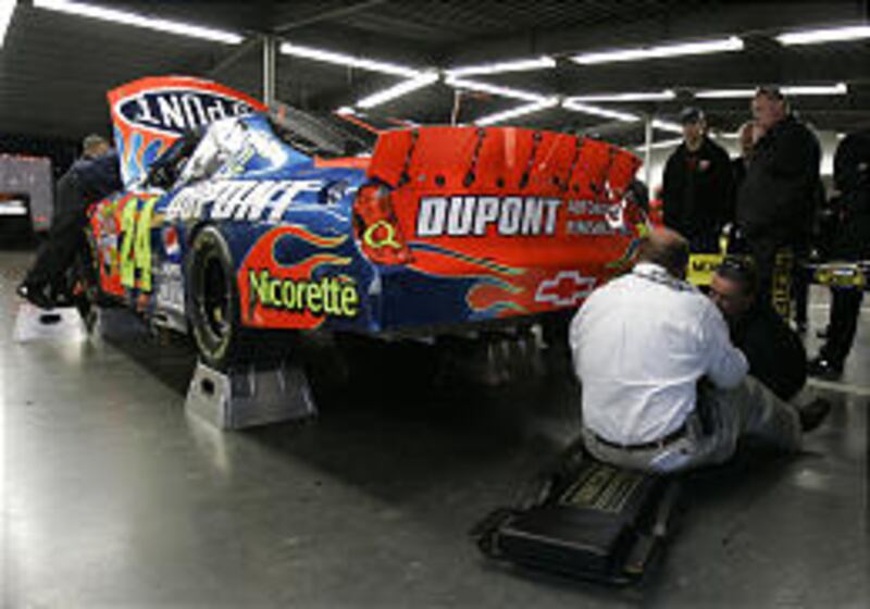 NASCAR officials inspect the car of driver Jeff Gordon on Thursday. It failed the inspection.