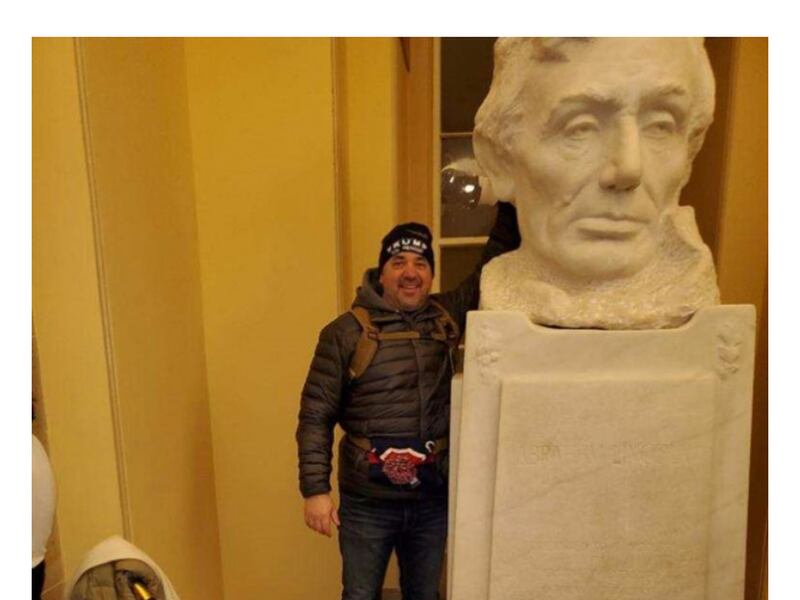 In a screenshot of Michael Hardin's federal complaint, a photo provided to the FBI by a tipster shows a man the tipster says is Hardin posing next to a bust of Abraham Lincoln in the U.S. Capitol Crypt on Jan. 6, 2021.
