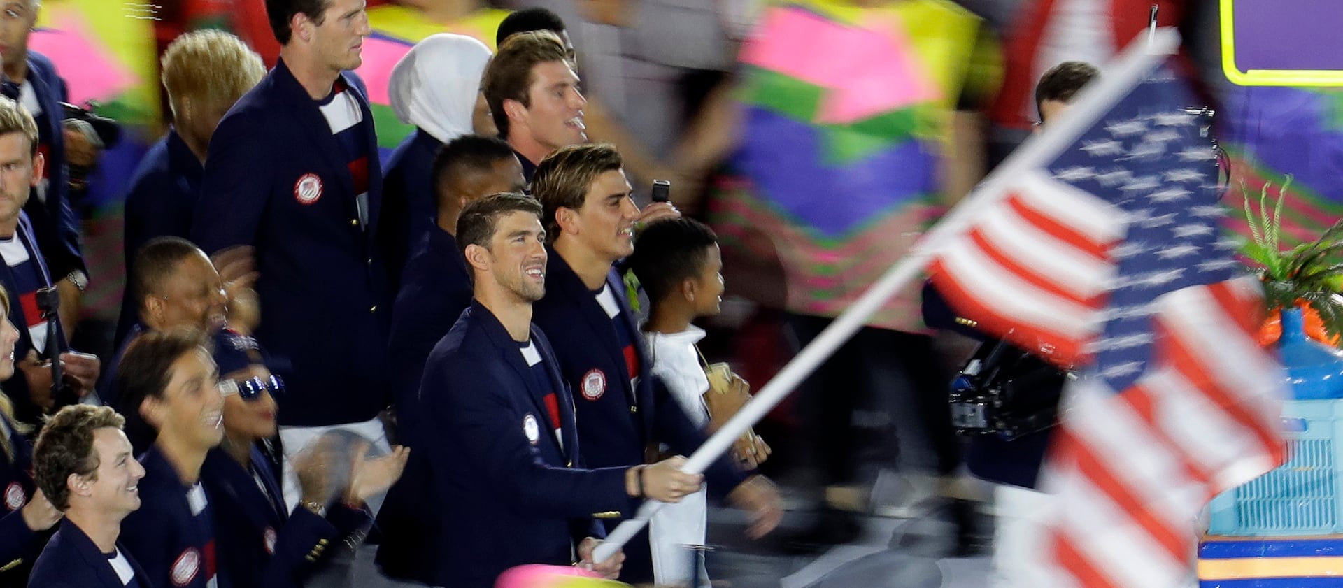 Michael Phelps carries the flag of the United States during the opening ceremony for the 2016 Summer Olympics.