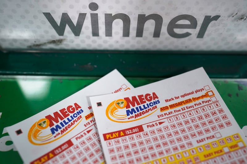 Mega Millions play slips are displayed on a gaming kiosk.