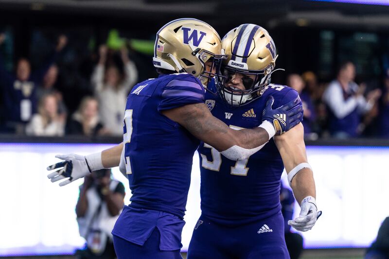 Washington tight end Jack Westover, right, and wide receiver Ja’Lynn Polk celebrate a touchdown.