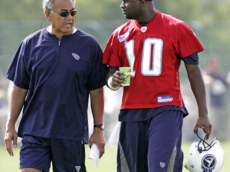 Tennessee Titans offensive coordinator Norm Chow, left, talks with quarterback Vince Young at an NFL football training camp last July in Nashville, Tenn. The Titans fired Chow on Tuesday after a season of struggling to score points, although the team reac