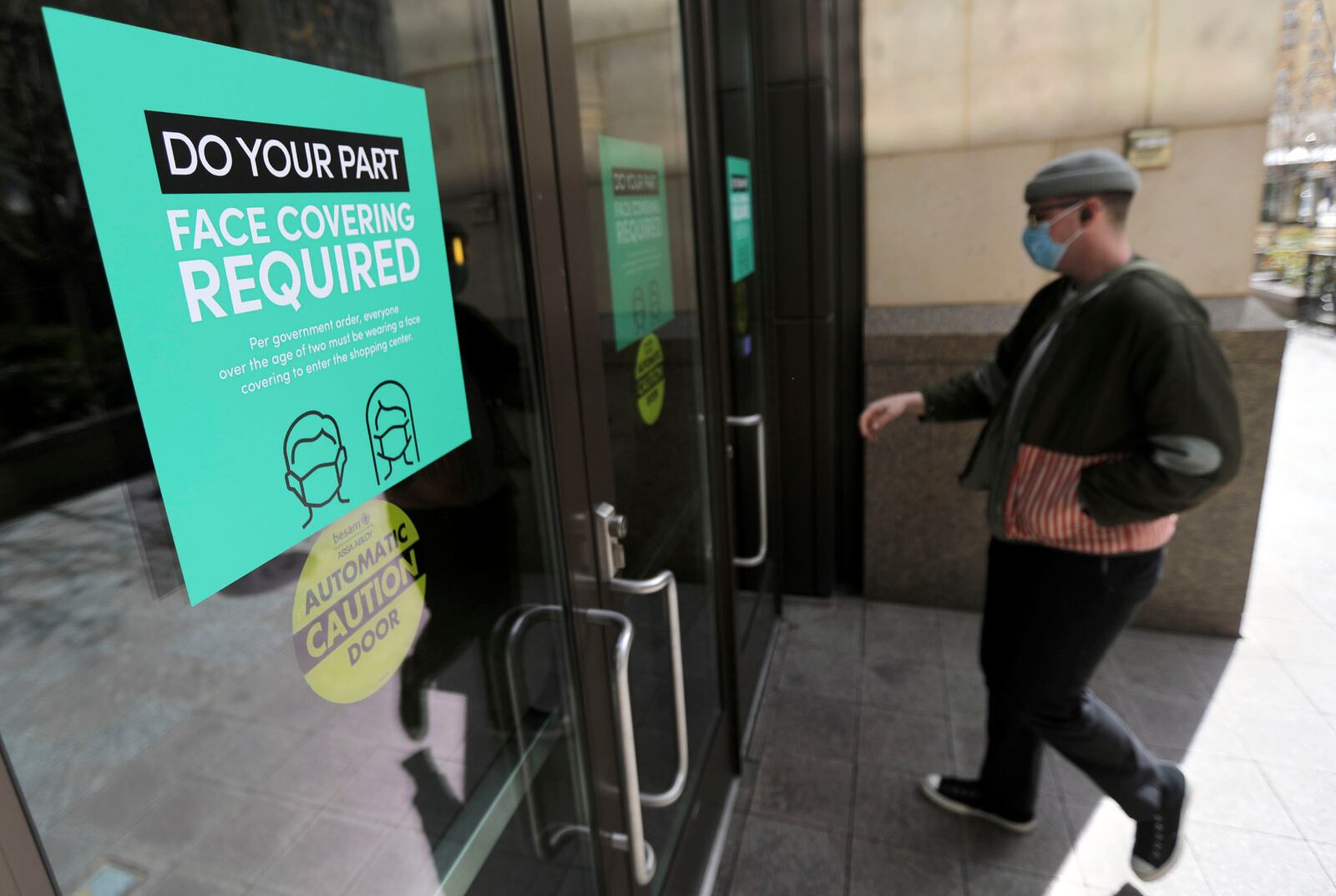 A sign on the entrance of City Creek Center in Salt Lake City alerts patrons of Utah mask mandate in response to coronavirus. 