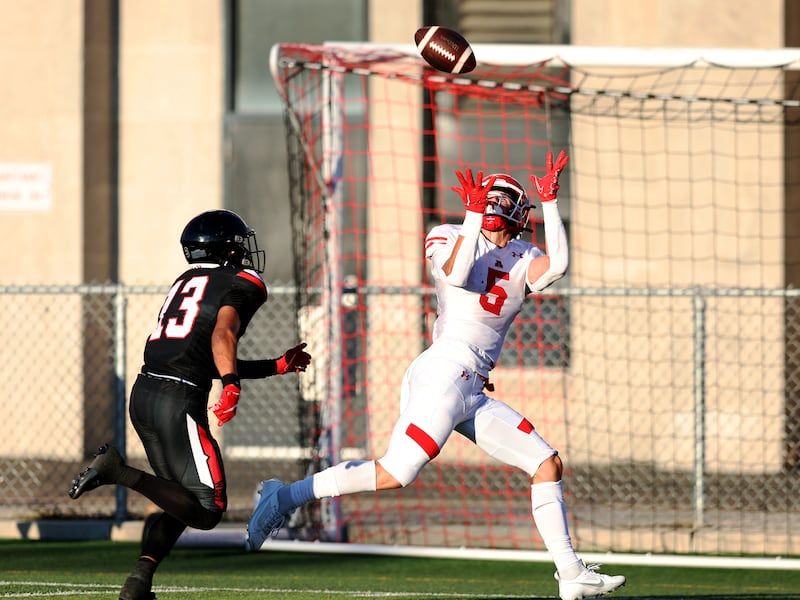 American Fork’s Davis Andrews reaches up for a long pass and touchdown ahead of West’s Lava Vailahi as the two teams play in Salt Lake City on Friday, Aug. 25, 2023. AF won 45-21.