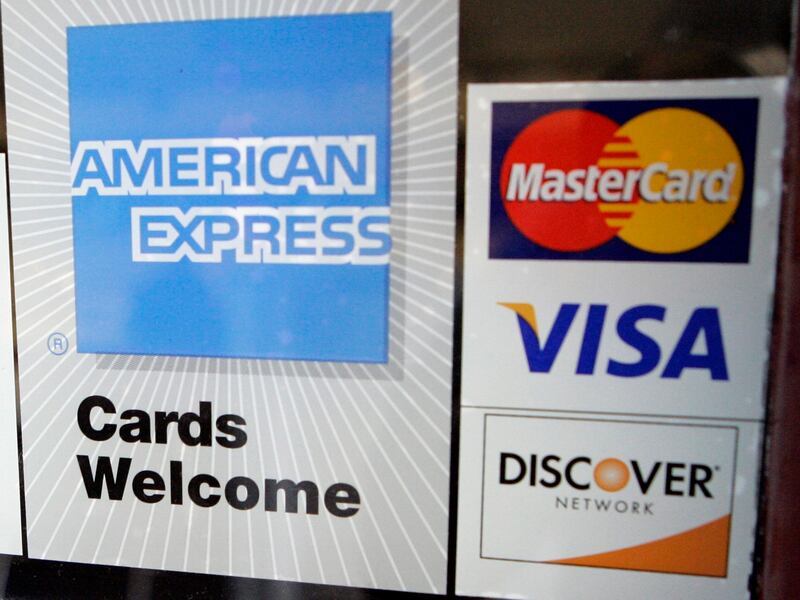 Credit card stickers are shown in the window of a bowling alley.
