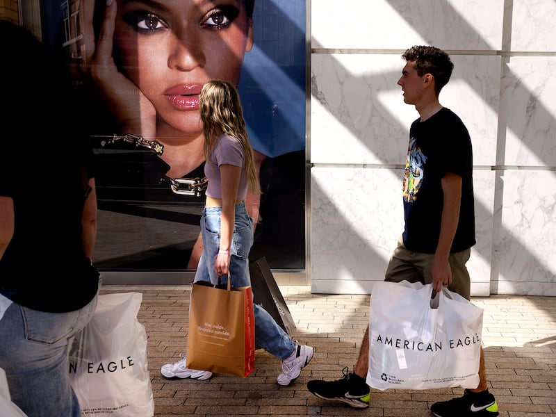 Michelle Bishop, left, and her children, Londyn and Logan, shop at City Creek Center in Salt Lake City on Thursday, Oct. 20, 2022.
