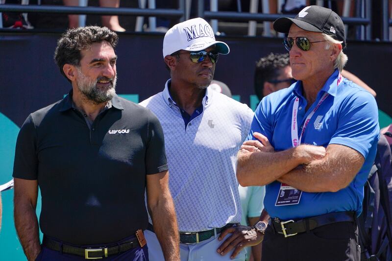 Yasir Al-Rumayyan, left, and Greg Norman, CEO of LIV Golf, watch an LIV tournament in 2022.
