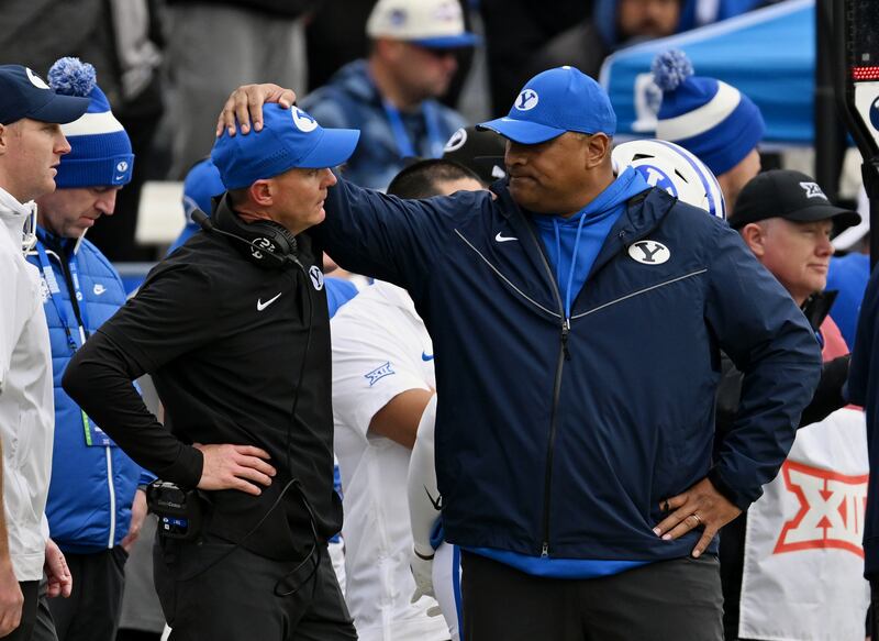 BYU head coach Kalani Sitake puts his hand on associate head coach and defensive coordinator Jay Hill on Nov. 18, 2023.