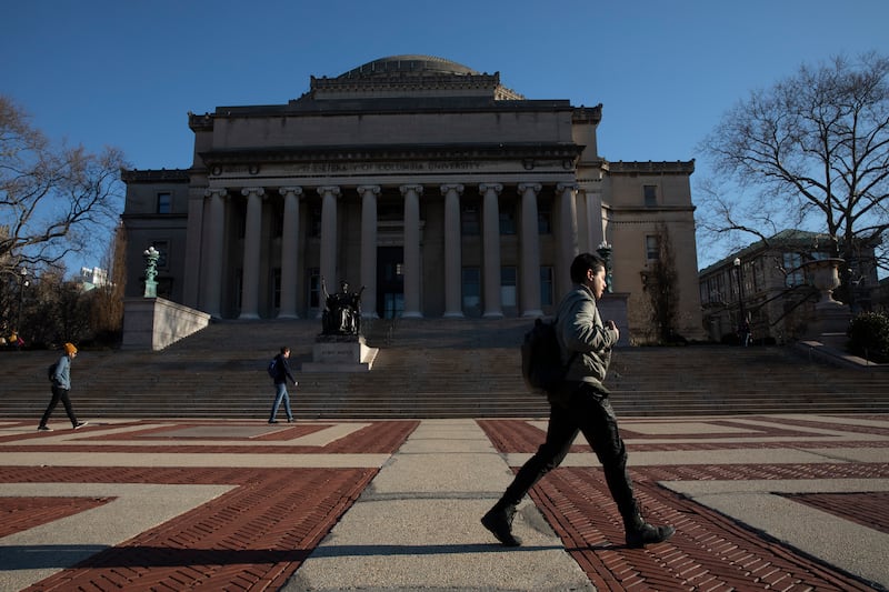 A man walks past Low Library on the Columbia University campus.