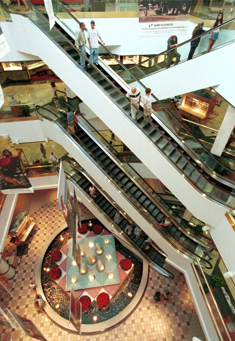 Shoppers ride the escalators in Crossroads Mall Thursday in Salt Lake City on July 16, 1998.