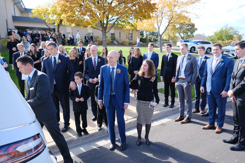 President Henry B. Eyring watches as the casket of his wife, Sister Kathleen Eyring, is loaded into a hearse after her funeral.