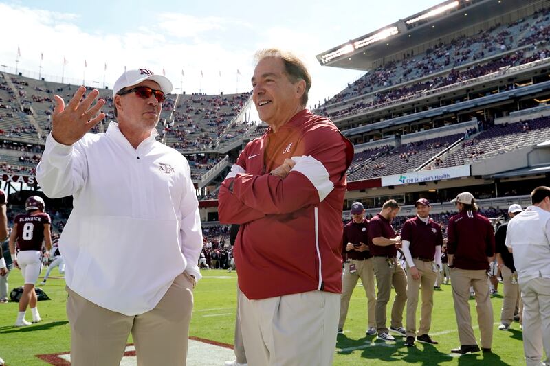 Texas A&M head coach Jimbo Fisher, left, talks to Alabama head coach Nick Saban before the start of a college football game.