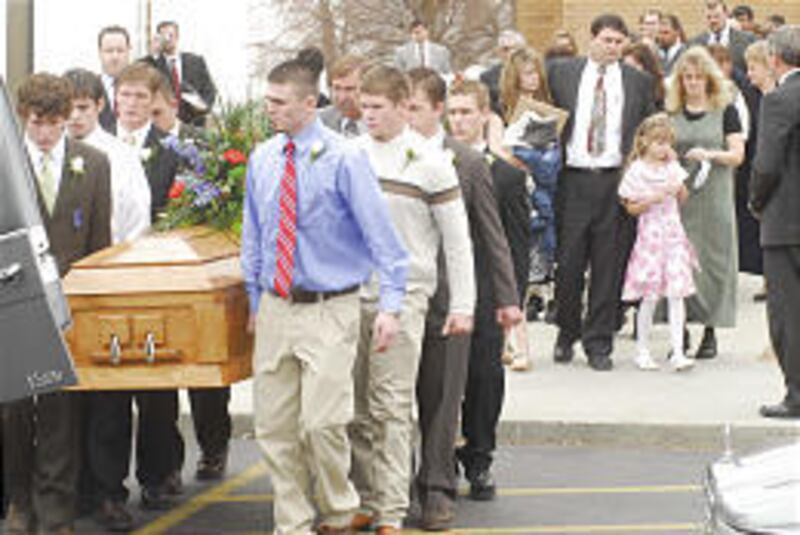 Pallbearers carry caskets of Brooke and Brant Probst following services in Emmett, Idaho, Saturday.